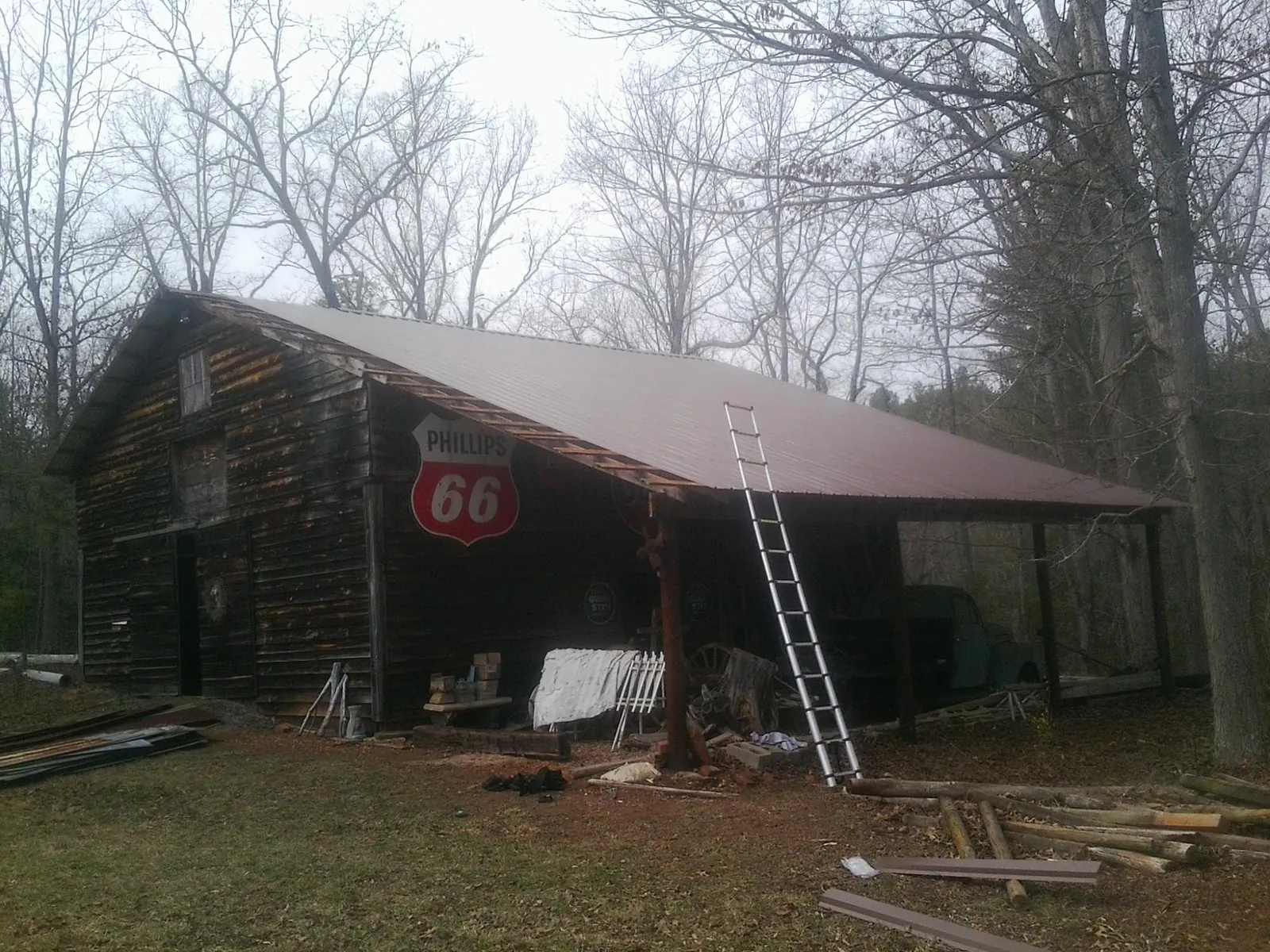 New metal roof on an open sided timber barn with a vintage sign in Hibernia