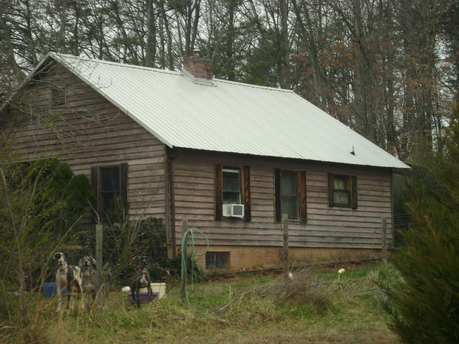 White metal roof on an old wood sided farmhouse, from a Metal Roof Installation job in Hibernia